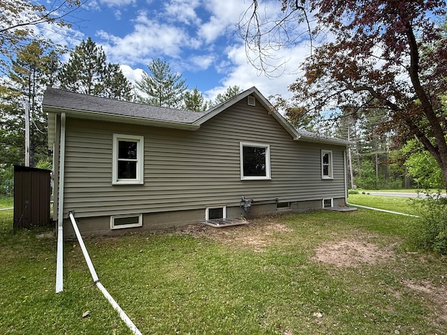 11966 Lindquist Rd, Hibbing, MN 55746 - view of side of property featuring a lawn and roof with shingles