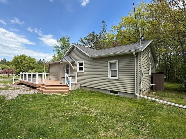 11966 Lindquist Rd, Hibbing, MN 55746 - view of front of house with a deck, a front yard, and roof with shingles