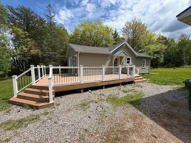 11966 Lindquist Rd, Hibbing, MN 55746 - view of front of property with a deck, a front yard, and a shingled roof