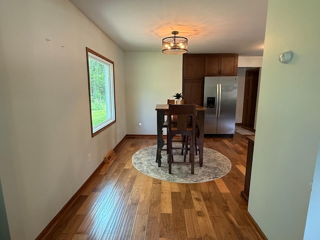 11966 Lindquist Rd, Hibbing, MN 55746 - dining space with dark wood-style flooring, a chandelier, and baseboards