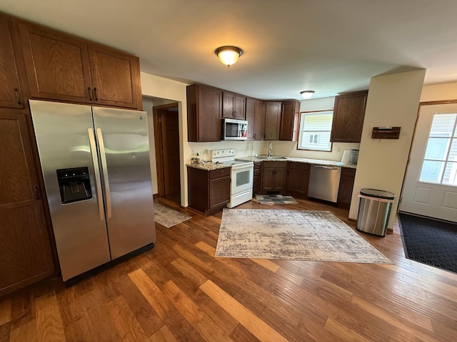 11966 Lindquist Rd, Hibbing, MN 55746 - kitchen with stainless steel appliances, a sink, dark wood-style flooring, and dark brown cabinetry
