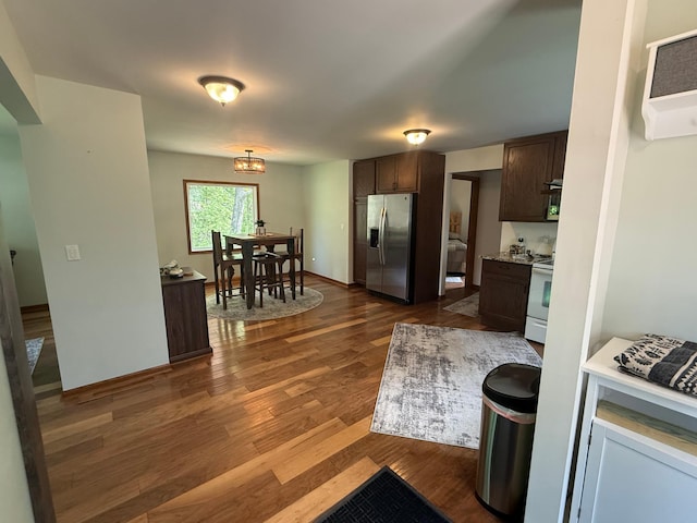 11966 Lindquist Rd, Hibbing, MN 55746 - kitchen with stainless steel refrigerator with ice dispenser, dark wood-style floors, white range oven, and dark brown cabinets