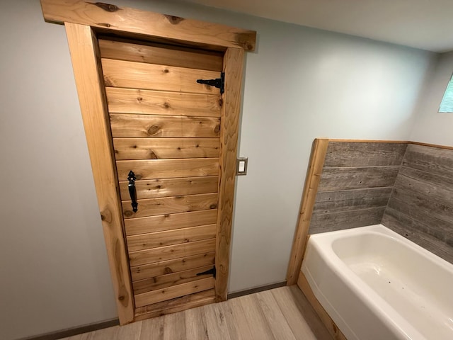 11966 Lindquist Rd, Hibbing, MN 55746 - bathroom featuring a garden tub and wood finished floors
