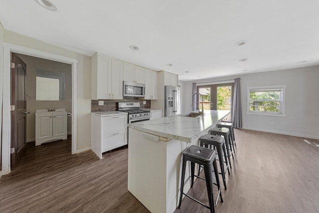 517 1st Ave NW, Winnebago, MN 56098 - kitchen with a sink, appliances with stainless steel finishes, dark wood-style flooring, white cabinetry, and recessed lighting