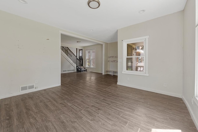517 1st Ave NW, Winnebago, MN 56098 - unfurnished room with stairway, baseboards, and wood finished floors