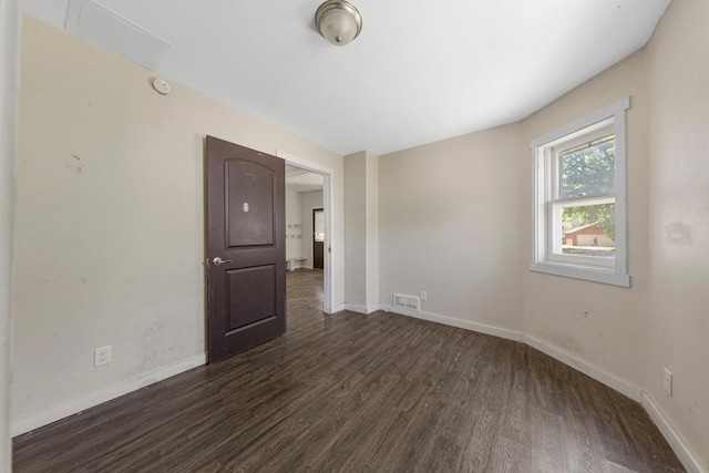 517 1st Ave NW, Winnebago, MN 56098 - empty room with dark wood finished floors, baseboards, and a smoke detector
