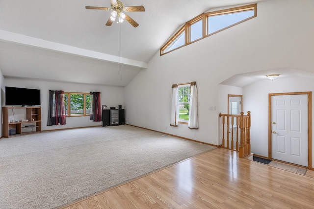 8187 230th St E, Faribault, MN 55021 - unfurnished living room featuring a ceiling fan, wood finished floors, high vaulted ceiling, and baseboards
