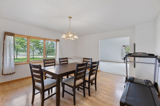 8187 230th St E, Faribault, MN 55021 - dining space featuring a chandelier, light wood-type flooring, and baseboards