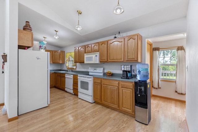 8187 230th St E, Faribault, MN 55021 - kitchen with white appliances, light wood-style floors, vaulted ceiling, a sink, and baseboards