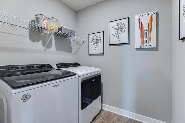 1025 Shoreview Dr, Jordan, MN 55352 - laundry area featuring washing machine and dryer, wood finished floors, and baseboards