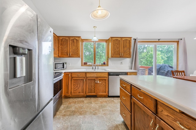 810 7th Ave N, Sauk Rapids, MN 56379 - kitchen with appliances with stainless steel finishes, a sink, and brown cabinets