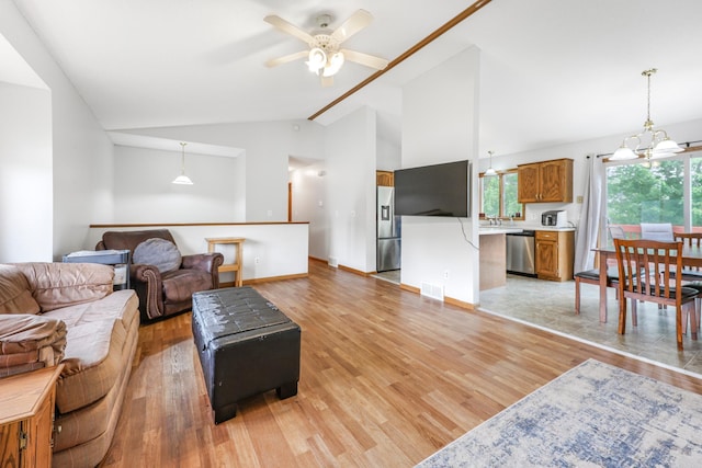 810 7th Ave N, Sauk Rapids, MN 56379 - living room featuring a ceiling fan, light wood finished floors, high vaulted ceiling, and baseboards