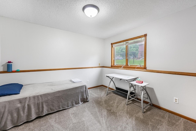 810 7th Ave N, Sauk Rapids, MN 56379 - unfurnished bedroom featuring a textured ceiling, carpet, and baseboards