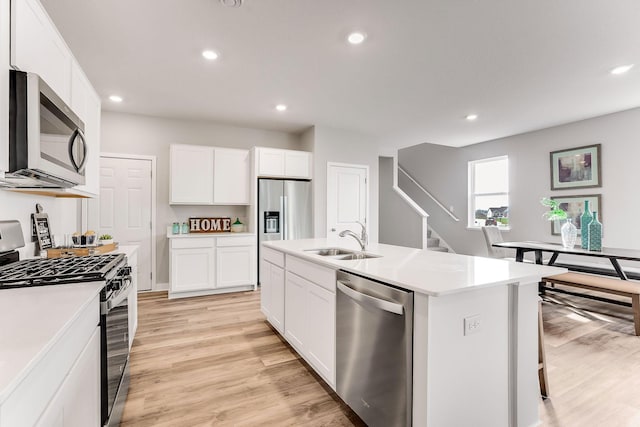 1083 Shoreview Dr, Jordan, MN 55352 - kitchen with appliances with stainless steel finishes, a sink, light wood finished floors, recessed lighting, and light countertops