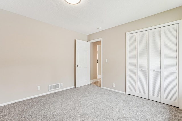 6535 Dawn Way, Inver Grove Heights, MN 55076 - unfurnished bedroom with light carpet, a closet, and a textured ceiling