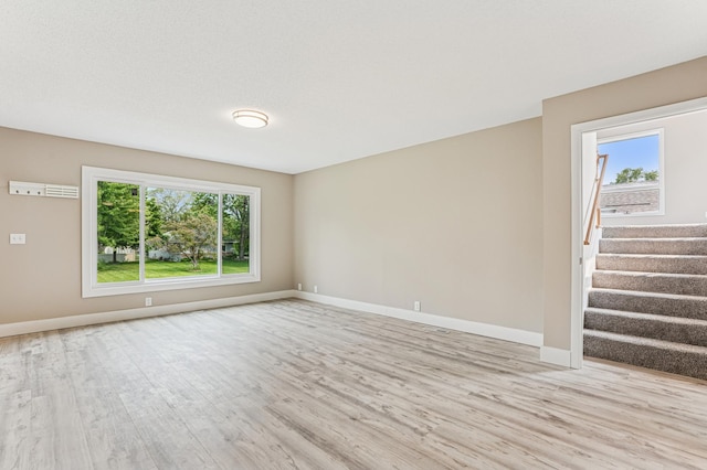 6535 Dawn Way, Inver Grove Heights, MN 55076 - unfurnished room featuring light wood-type flooring and stairs