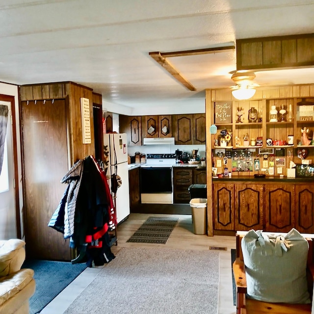 128 Park Cir, Ottertail, MN 56571 - kitchen featuring electric range oven, freestanding refrigerator, and ventilation hood