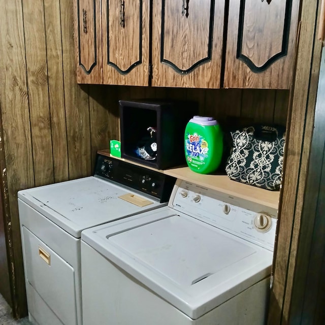 128 Park Cir, Ottertail, MN 56571 - washroom with washing machine and clothes dryer, wooden walls, and cabinet space