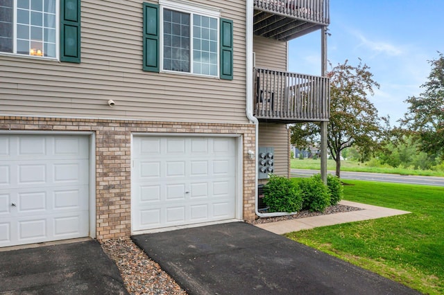 16047 72nd St NE, Otsego, MN 55330 - view of side of property with a balcony, an attached garage, a lawn, and driveway
