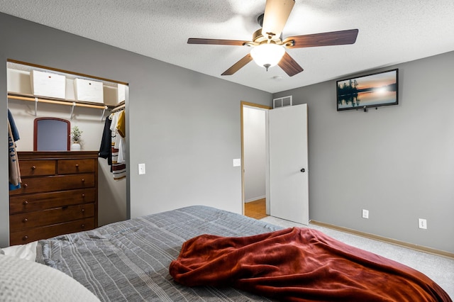 16047 72nd St NE, Otsego, MN 55330 - carpeted bedroom with baseboards, a ceiling fan, a textured ceiling, and a closet