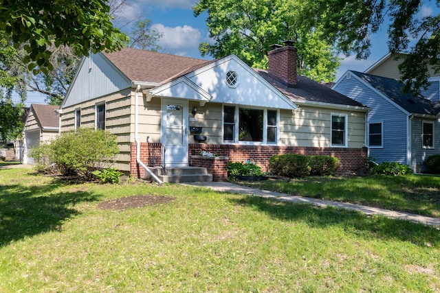5652 Thomas Ave S, Minneapolis, MN 55410 - view of front of home featuring brick siding, a chimney, a front lawn, and a shingled roof