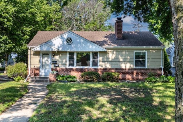 5652 Thomas Ave S, Minneapolis, MN 55410 - view of front facade featuring brick siding, a chimney, a front lawn, and roof with shingles