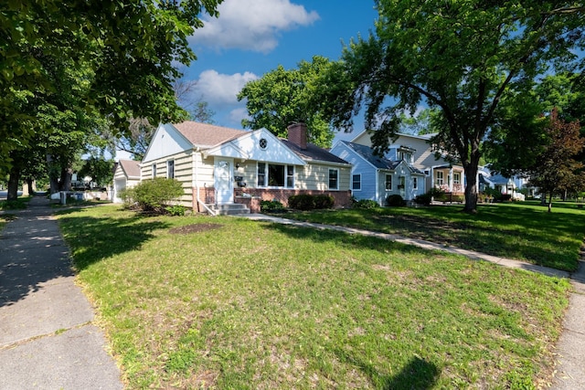 5652 Thomas Ave S, Minneapolis, MN 55410 - bungalow featuring brick siding, a front lawn, and a chimney
