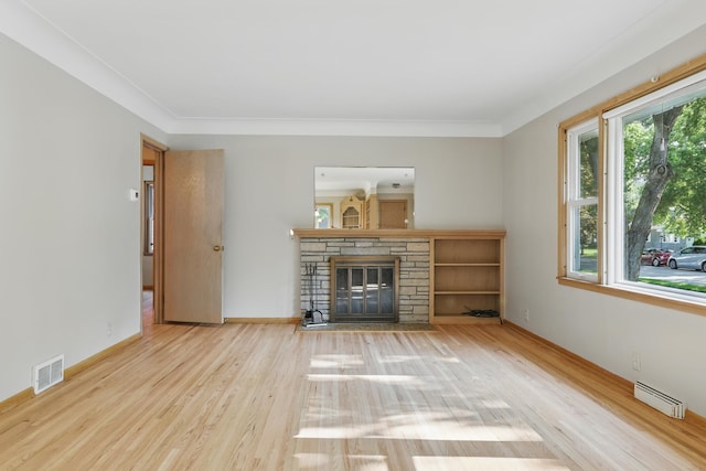 5652 Thomas Ave S, Minneapolis, MN 55410 - living room featuring wood finished floors, a fireplace, a baseboard heating unit, baseboards, and crown molding