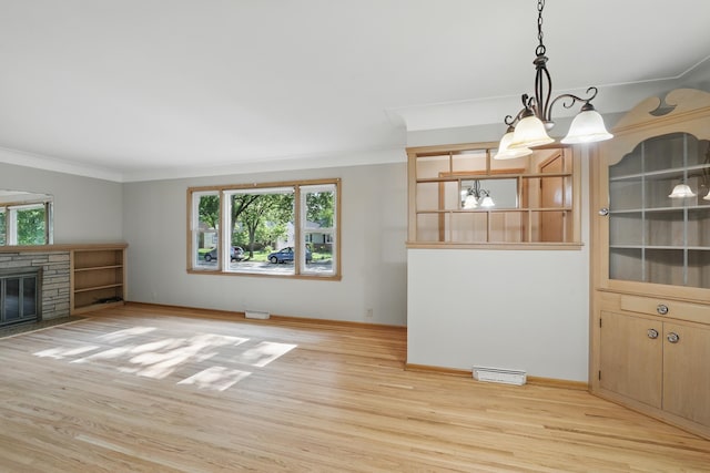 5652 Thomas Ave S, Minneapolis, MN 55410 - unfurnished living room featuring light wood-style floors, a chandelier, ornamental molding, baseboards, and a stone fireplace