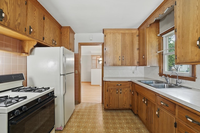 5652 Thomas Ave S, Minneapolis, MN 55410 - kitchen featuring gas range, a sink, light floors, light countertops, and decorative backsplash