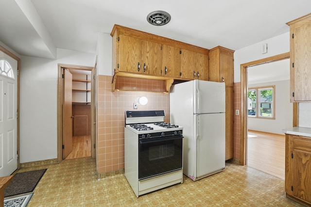 5652 Thomas Ave S, Minneapolis, MN 55410 - kitchen with gas range, freestanding refrigerator, light floors, and light countertops