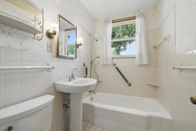 5652 Thomas Ave S, Minneapolis, MN 55410 - full bathroom featuring toilet, shower / bath combination, tile walls, and wallpapered walls