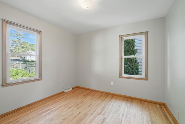 5652 Thomas Ave S, Minneapolis, MN 55410 - empty room with plenty of natural light, light wood finished floors, and baseboards