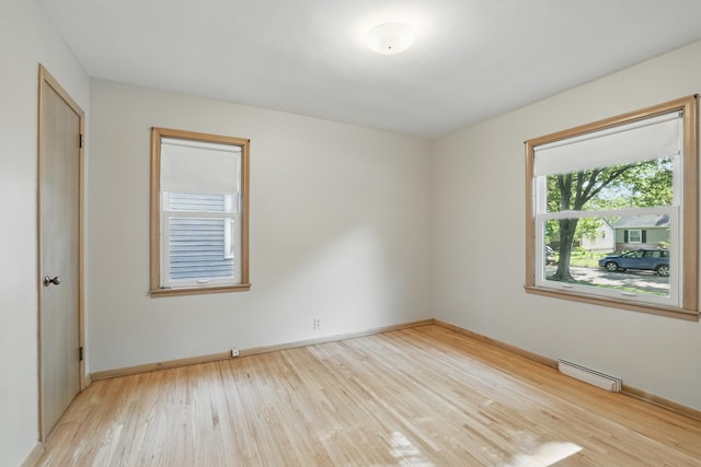5652 Thomas Ave S, Minneapolis, MN 55410 - spare room with light wood-type flooring, a baseboard heating unit, and baseboards