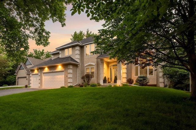 16976 81st Ave N, Maple Grove, MN 55311 - view of front of house with a front yard, an attached garage, driveway, and a shingled roof