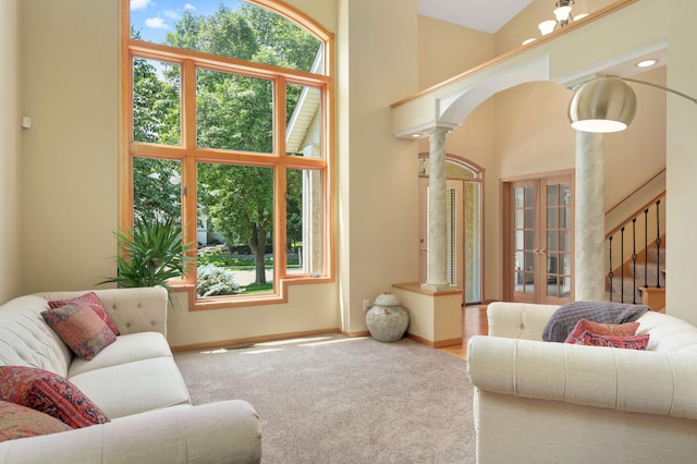 16976 81st Ave N, Maple Grove, MN 55311 - living area with decorative columns, french doors, stairway, baseboards, and carpet flooring