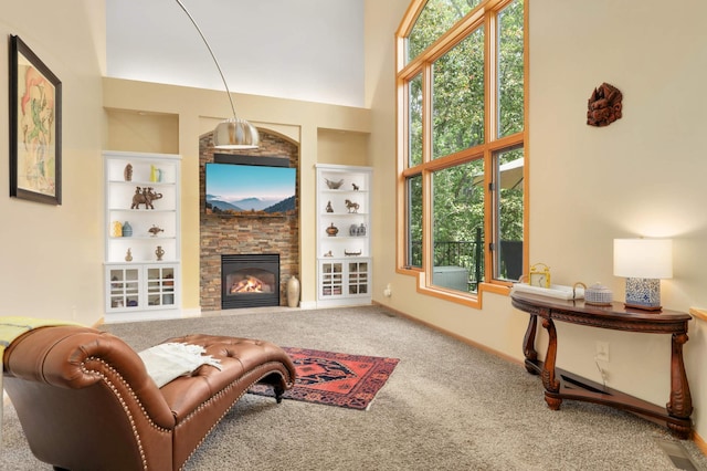 16976 81st Ave N, Maple Grove, MN 55311 - carpeted living room with healthy amount of natural light, a stone fireplace, baseboards, built in shelves, and a towering ceiling