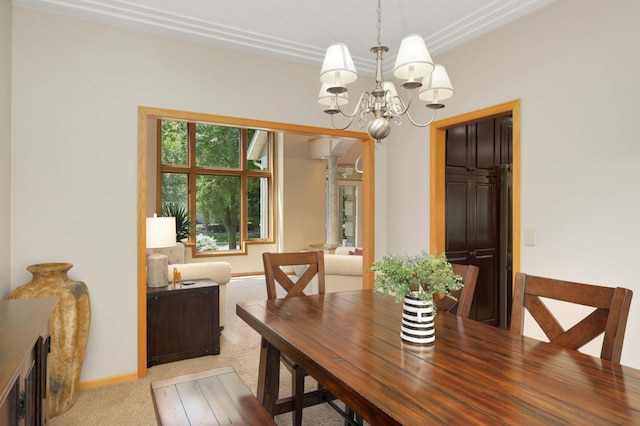 16976 81st Ave N, Maple Grove, MN 55311 - carpeted dining space featuring decorative columns, a chandelier, and baseboards
