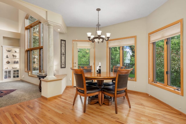 16976 81st Ave N, Maple Grove, MN 55311 - dining area featuring decorative columns, light wood-type flooring, a chandelier, and baseboards