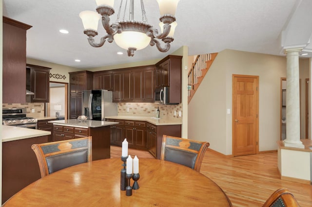 16976 81st Ave N, Maple Grove, MN 55311 - dining space featuring decorative columns, light wood-type flooring, recessed lighting, a chandelier, and stairway