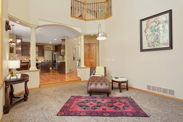 16976 81st Ave N, Maple Grove, MN 55311 - sitting room with decorative columns, light colored carpet, a towering ceiling, baseboards, and recessed lighting