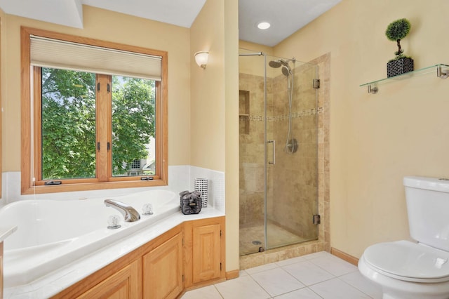 16976 81st Ave N, Maple Grove, MN 55311 - bathroom with toilet, a stall shower, a garden tub, tile patterned flooring, and baseboards