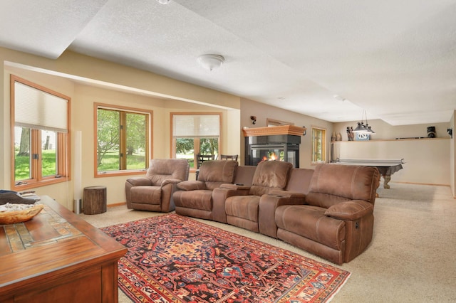 16976 81st Ave N, Maple Grove, MN 55311 - living room featuring carpet flooring, a textured ceiling, a glass covered fireplace, and baseboards