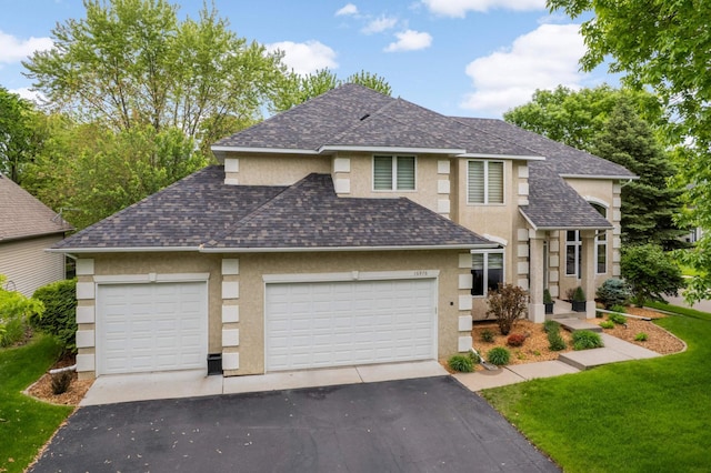 16976 81st Ave N, Maple Grove, MN 55311 - view of front of property featuring driveway, stucco siding, a shingled roof, and a garage