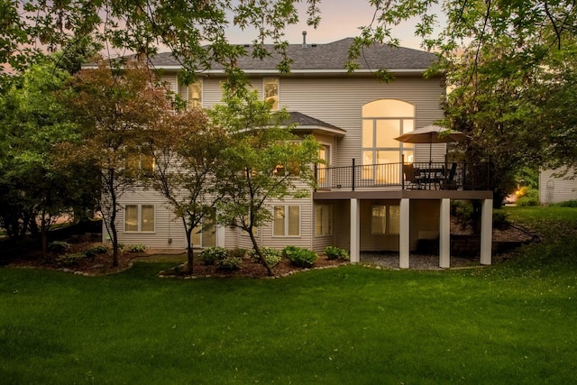 16976 81st Ave N, Maple Grove, MN 55311 - back of house at dusk featuring a yard, a wooden deck, and roof with shingles