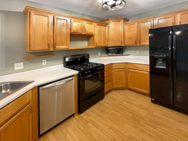 2002 Willow Cir, Centerville, MN 55038 - kitchen featuring black appliances, light wood finished floors, light countertops, a textured ceiling, and open shelves