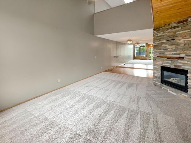 2002 Willow Cir, Centerville, MN 55038 - unfurnished living room featuring carpet floors, baseboards, a towering ceiling, and a fireplace