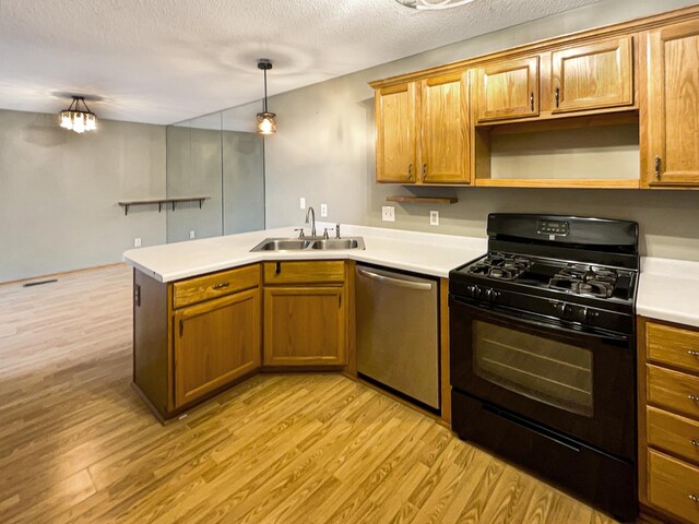 2002 Willow Cir, Centerville, MN 55038 - kitchen featuring black gas range, a sink, stainless steel dishwasher, a peninsula, and light wood-style flooring