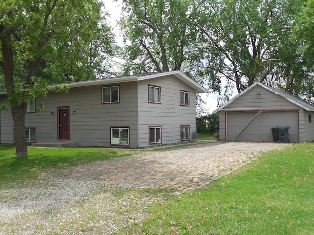 402 6th Ave, Round Lake, MN 56167 - back of house with a detached garage, an outbuilding, and a lawn