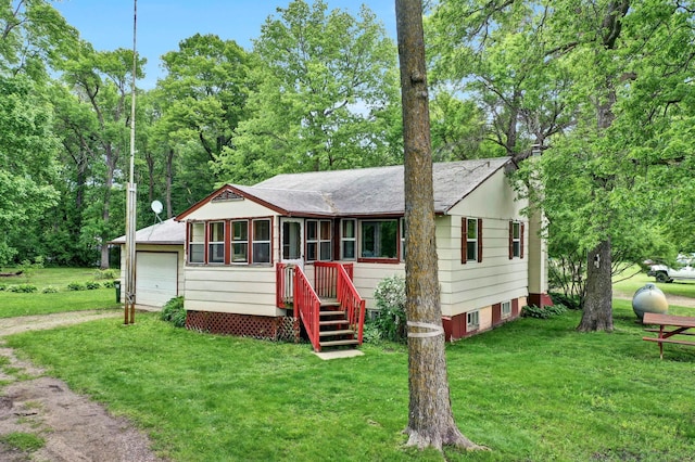 17266 Ttt Rd, Eden Lake Twp, MN 55329 - view of front of house featuring a front lawn, a garage, and a shingled roof